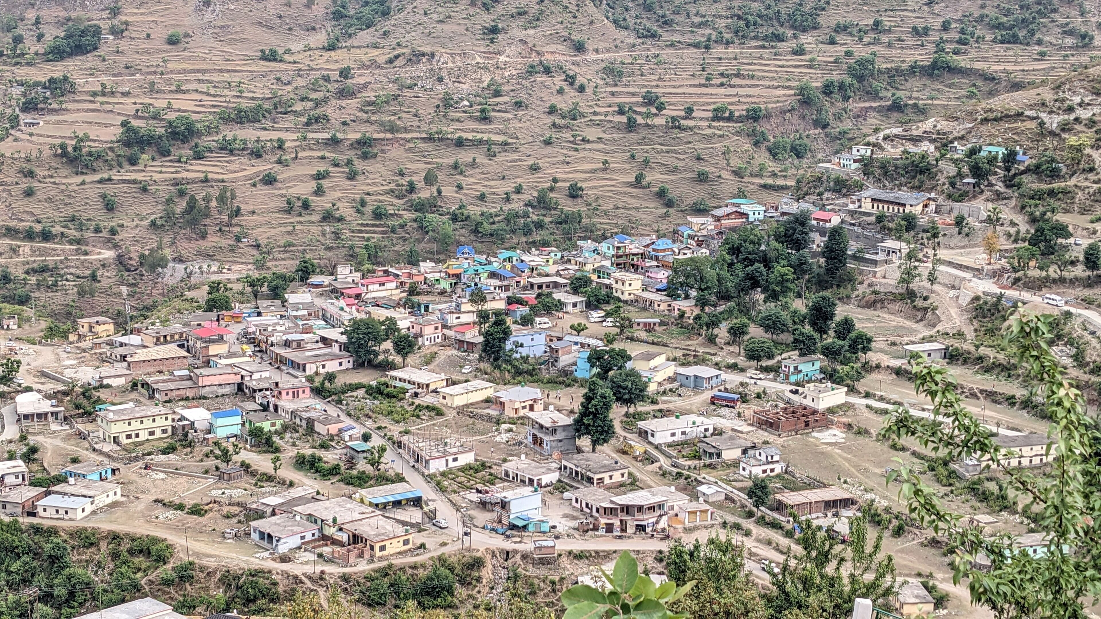 A rural village with scattered houses and terraced fields.