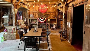 A rustic interior with a wooden dining area, American flags, and a Coca-Cola sign.