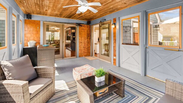 A covered patio area with wicker furniture, a ceiling fan, and a view of the backyard. - The Gathering Place - For 6 with Fire Pit (Mashpee)