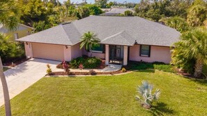 A single-story house with a sloped roof, a front porch, and a well-maintained lawn.