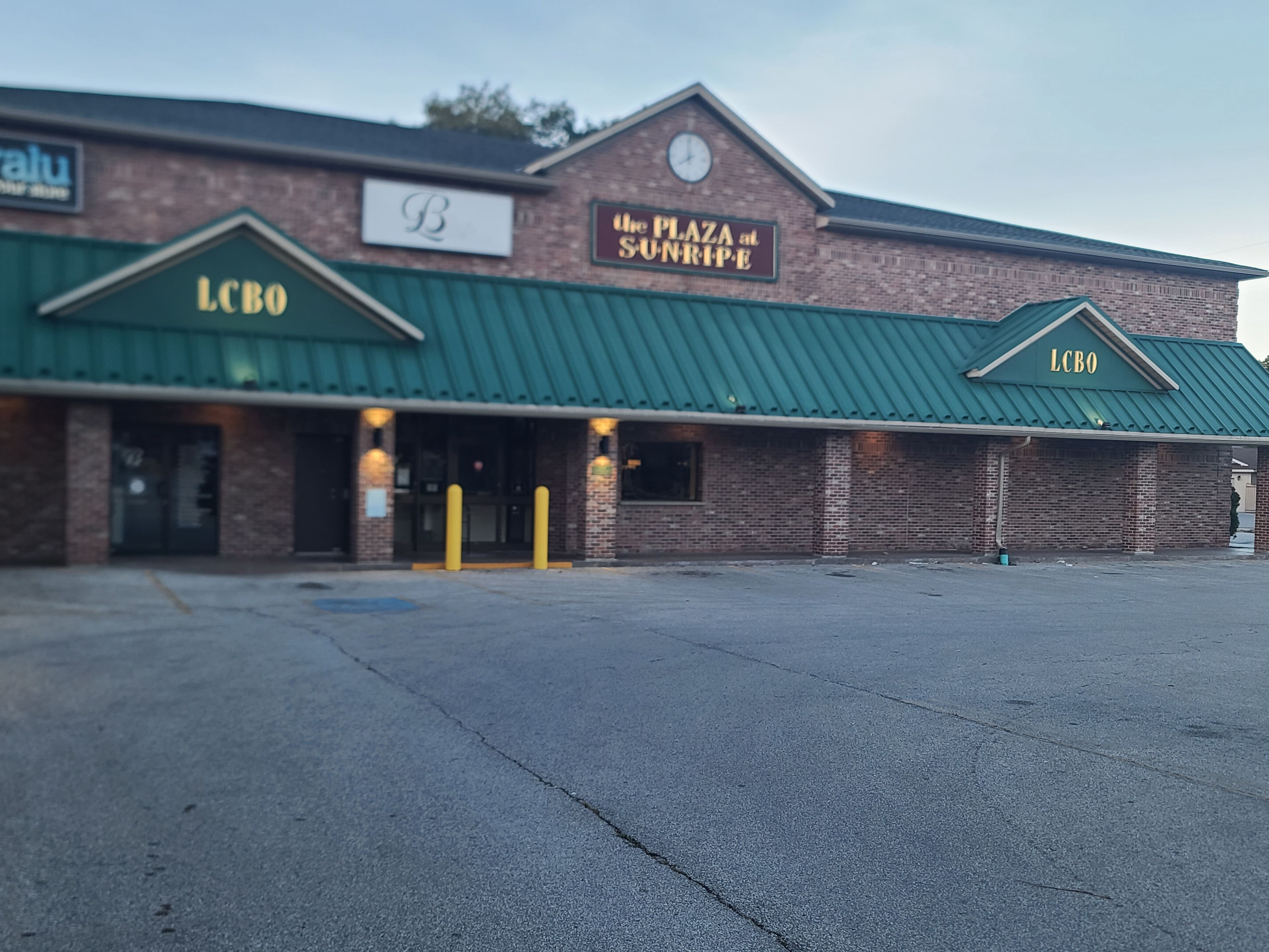 A building with a green roof and a sign that reads 'LCBO'.