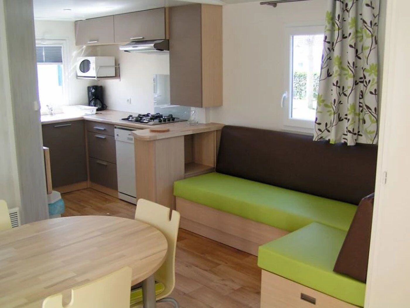 A compact kitchen with a dining area and a seating area.