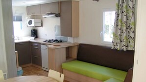 A compact kitchen with a dining area and a seating area.