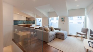 A modern apartment with a living area, kitchen, and balcony. - FLH Glória 70  Duplex I (Lisbon)