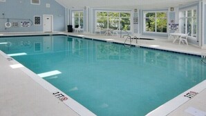 An indoor swimming pool with clear water, white walls, and a tiled floor. - Fall and early winter weeks available at Tupelo Bay 3BR Villa! (Myrtle Beach)