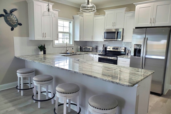 Kitchen With Granite and Island Seating for 4