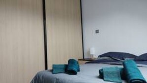 A hotel room with a bed, a nightstand, and a wall with a door. - Between lake and mountains, L'ange des Cimes welcomes you to Savines-le-Lac (Savines-le-Lac)