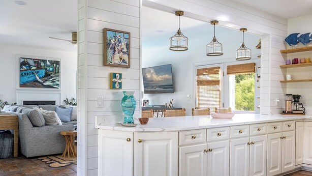 A spacious kitchen with white cabinetry, a large island, and pendant lighting. - Steele Away - 4 Bedrooms, 3.5 Baths, Private Pool, Emerald Isle (Emerald Isle)