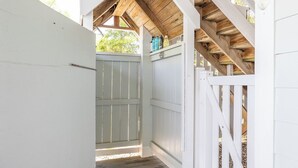 A wooden structure with a white door and a gate, leading to a covered area with a wooden ceiling. - Steele Away - 4 Bedrooms, 3.5 Baths, Private Pool, Emerald Isle (Emerald Isle)