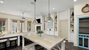 A spacious kitchen with a large island, pendant lights, and a built-in stove. - North Winston Villa|Easy Beach Access|Private Pool & Golf Cart (Inlet Beach)