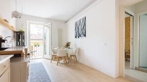 A modern kitchen with a dining area, a large window, and a view of the outside. - COZY NEST IN THE HEART OF VERONA (Verona)