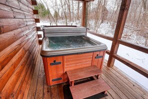 A wooden cabin with a hot tub and a wooden deck. - Woods Edge Cabin | Hocking Hills, Hot Tub, Pets (Logan)