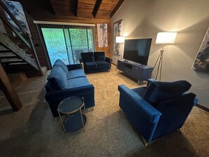 A living room with a sectional sofa, a drum set, a television, and a floor lamp. - Convenient, Clean, Cozy, Cheap 2 (Tallahassee)