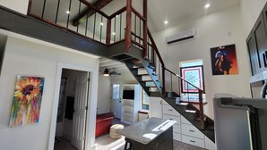 A modern kitchen with a built-in stove, a large island, and a refrigerator. - Welcome Home! Cozy, comfortable, quiet, secluded, private, beautiful. (Greenville)