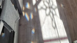 A room with a wooden floor, a white door, a desk with a chair, and a radiator. - Welcome Home! Cozy, comfortable, quiet, secluded, private, beautiful. (Greenville)