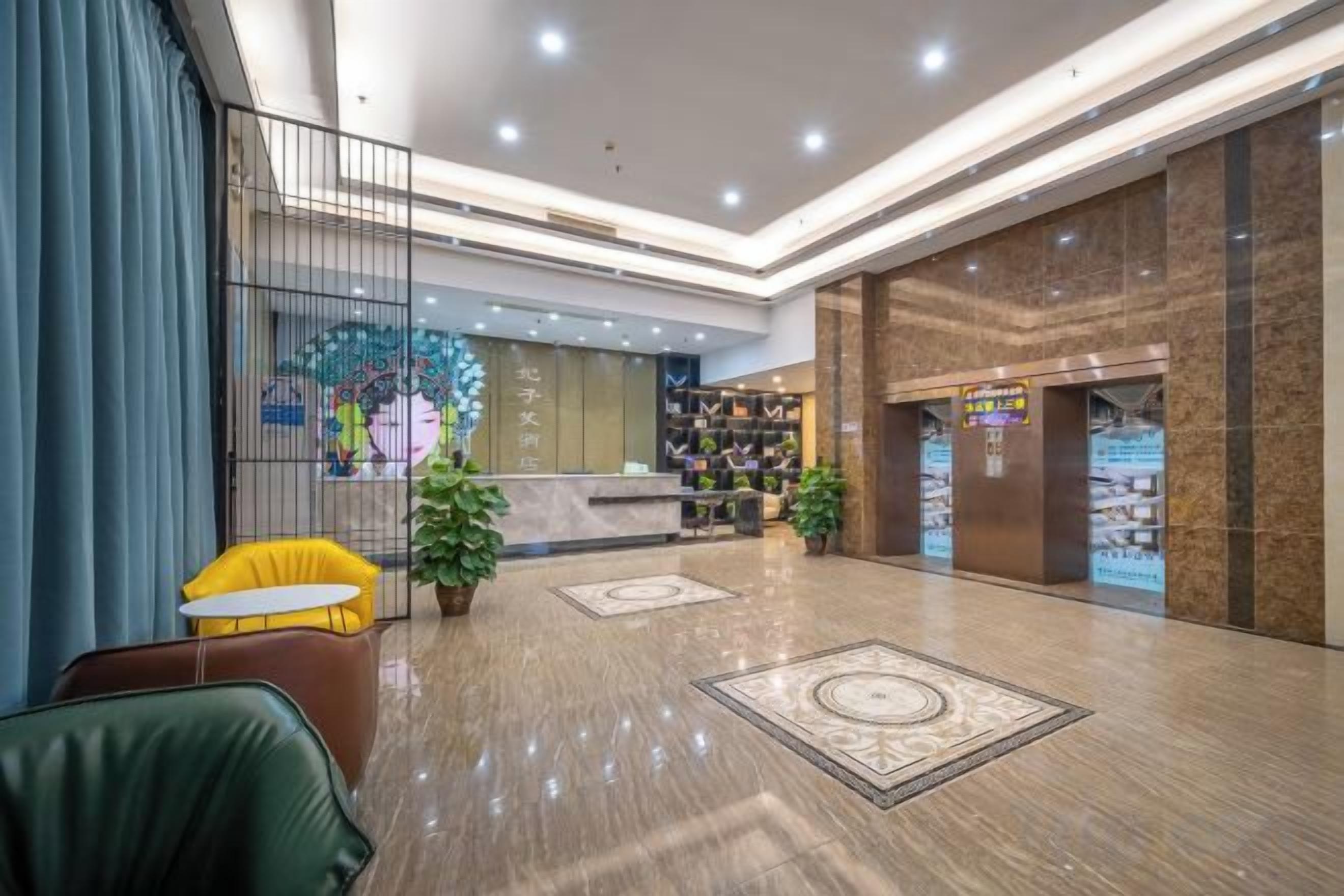 A hotel lobby with a reception desk, seating area, and a large decorative wall.