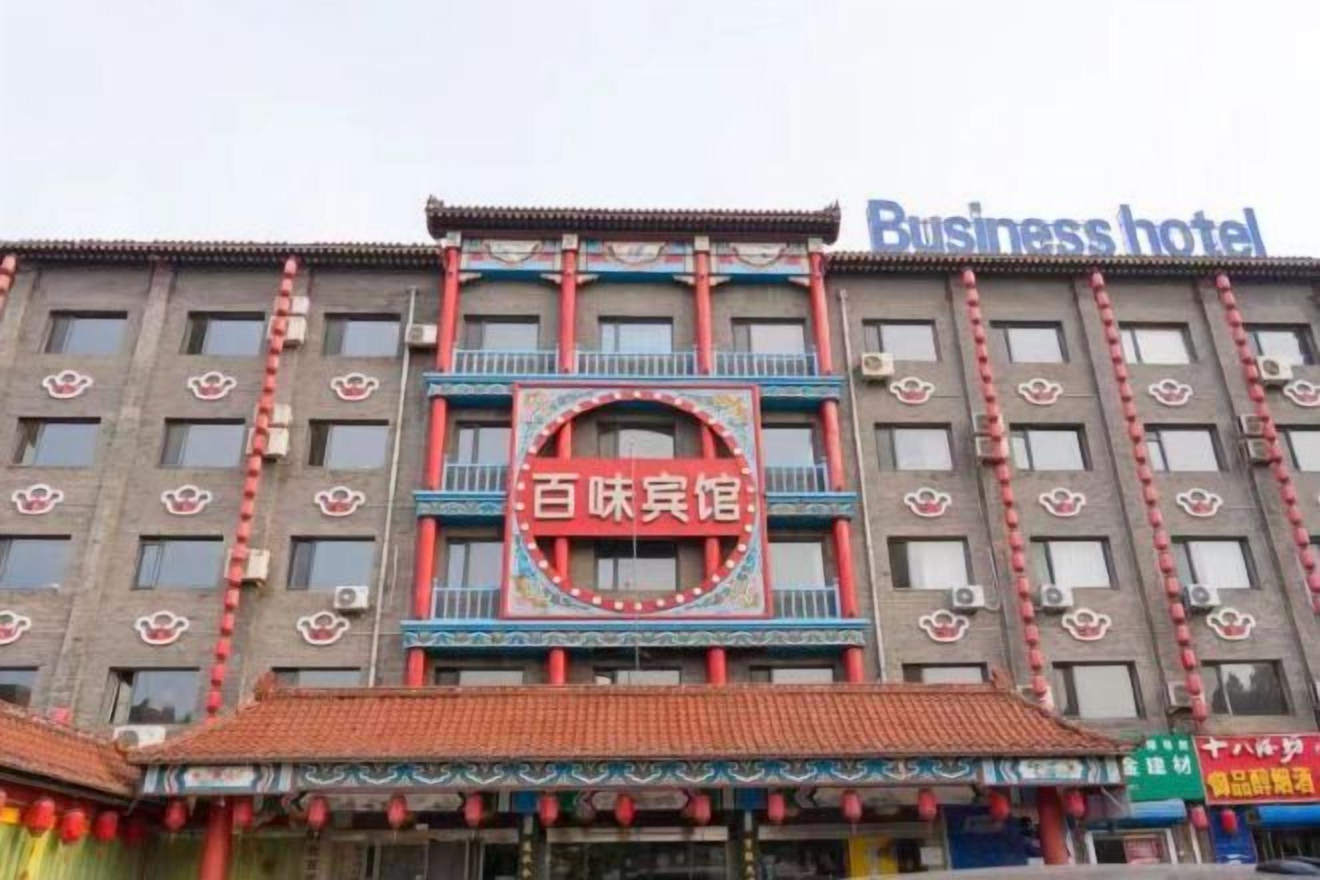 A building with a sign reading 'Business hotel' and another sign with Chinese characters.