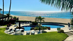 A pool area with lounge chairs and a sign labeled "MIRA VISTA".