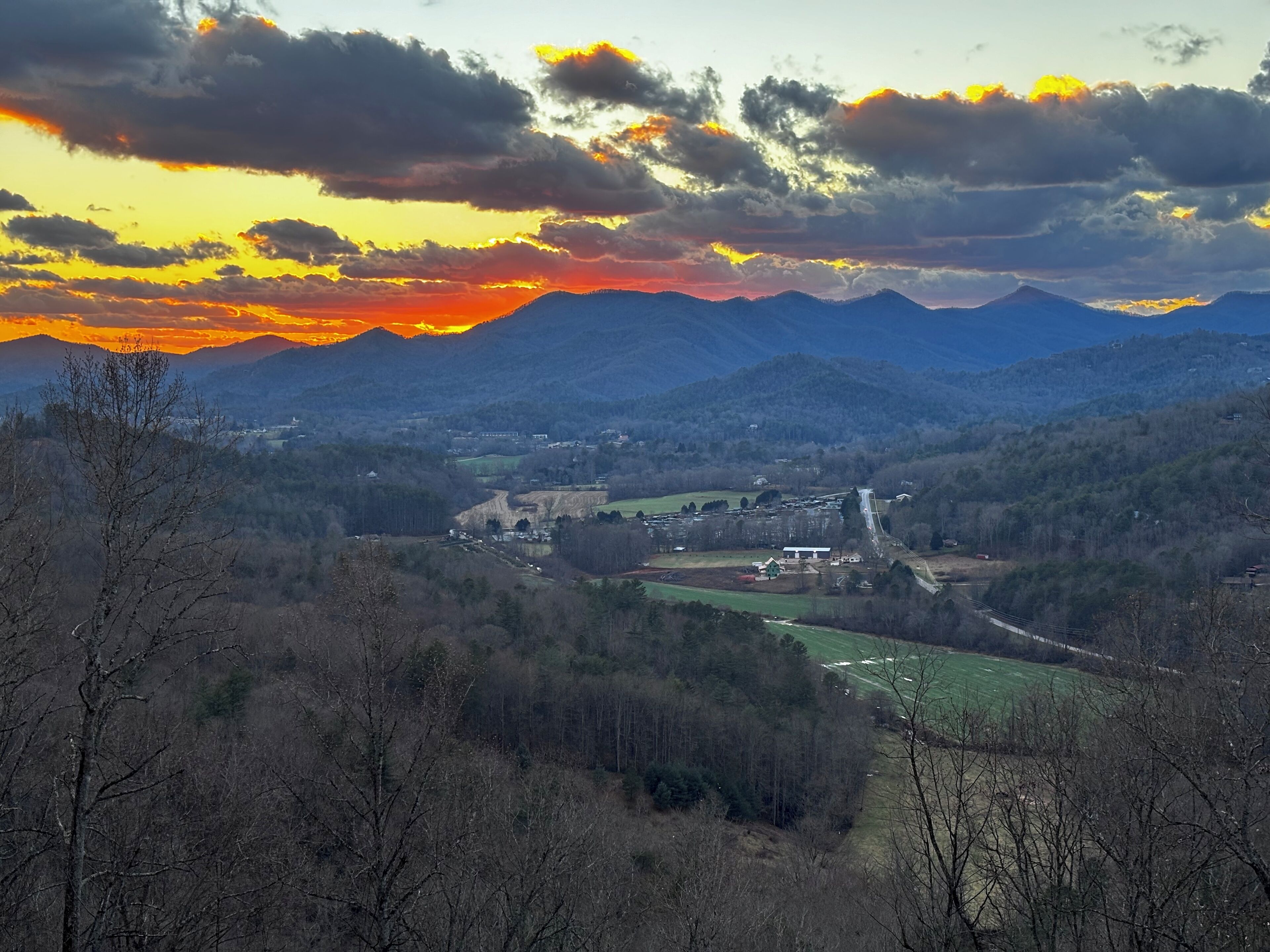 A mountainous landscape with a valley and a small town.