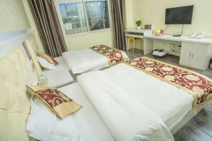 A hotel room with two beds, a desk, a television, and a window with curtains. - Tulip Fashion Hotel (Zhuquan Road Branch) (Zhaotong)