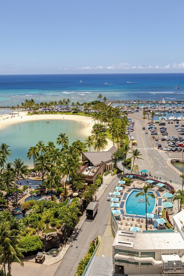 A resort with a large pool, a beach, and a marina.
