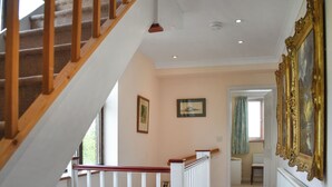A staircase with wooden railings leading to a landing. - Idyllic views, yet close to amenities and places of interest to explore. (Flordon)