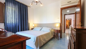 A hotel room with a bed, bedside tables, a desk, and a wardrobe. - 5 bedroom beautiful home in Sessa Cilento (Sessa Cilento)