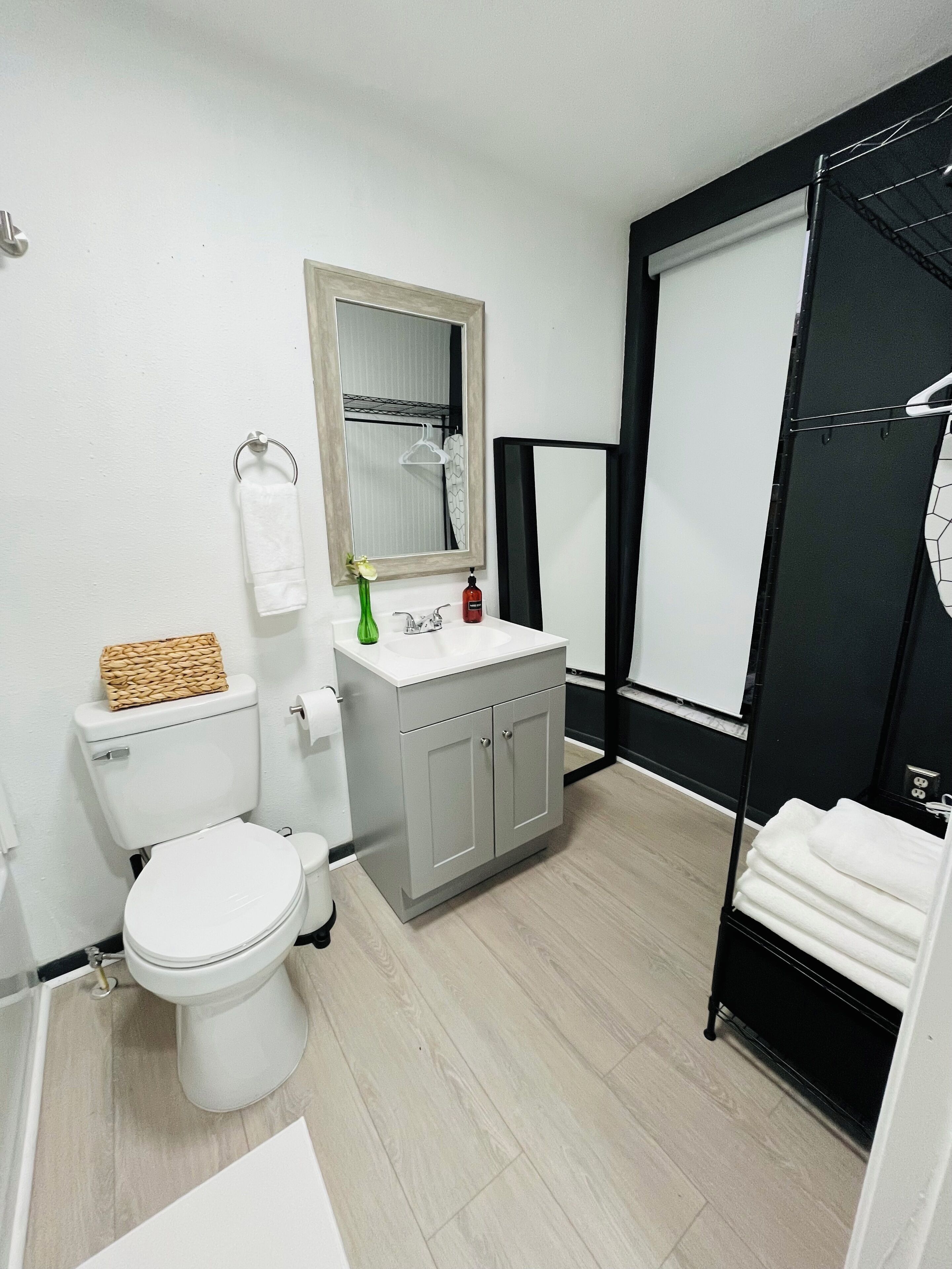 A modern bathroom with a toilet, sink, and shower area.