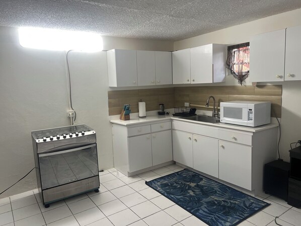Fridge, microwave, coffee/tea maker, cookware/dishes/utensils
