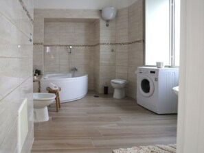 Superior Condo | Bathroom | Hair dryer, slippers, bidet, towels - RODA Apartments  (Naples)
