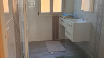 Shower, towels, soap, toilet paper