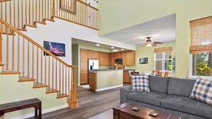 A spacious living area with a staircase, a kitchen, and a dining area. - Pools/Hot tub, BBQ area, Beach gear, Views, Tennis (Waikoloa Village)