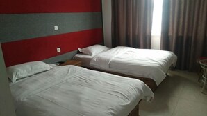 A hotel room with two single beds, a red and grey headboard, and a view of the outdoors through curtains. - Song Nantaiting Hotel (Junan County)