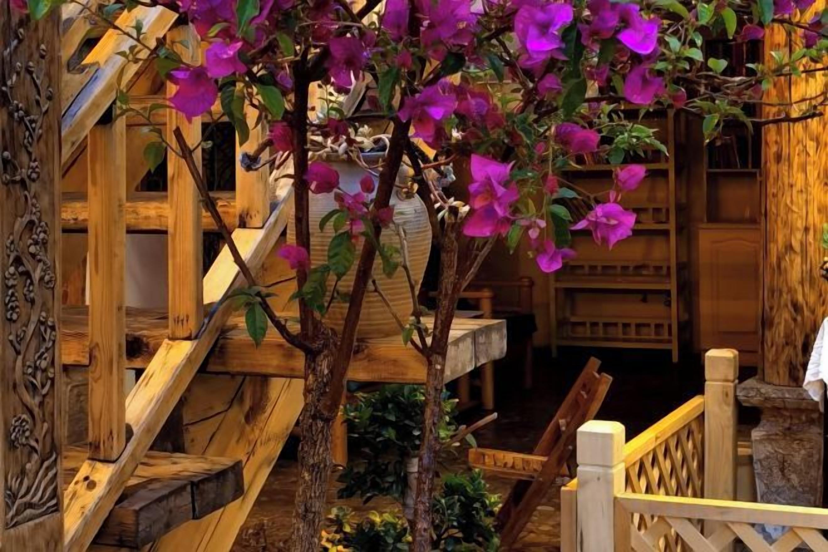A wooden staircase with a wooden railing and a wooden bench.