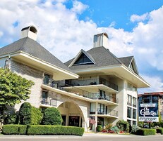 A multi-story hotel with a prominent American flag, balconies, and a sign for the Gillette brand.