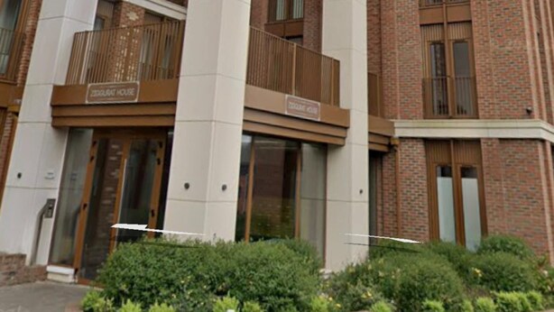 A multi-story building with "DOUBLE ROOM" signs above the doors, indicating the type of accommodation available. - Spacious 1 Bedroom Apartment in St Albans (St Albans)