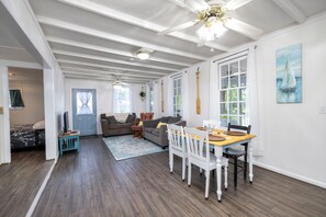 A spacious living area with a dining table, two sofas, and a ceiling fan. - Lakefront 3-bedroom home with private dock and ramp on Lake Marion, Manning, SC (Manning)