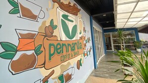 A mural advertising Pennantia Coffee & Snack on a building exterior. - Grand Mahoni Hotel (Banda Aceh)