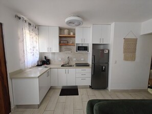 Fridge, microwave, coffee/tea maker, cookware/dishes/utensils