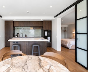 Stylish open-plan kitchen, dining and living space with seamless flow through to the bedroom.