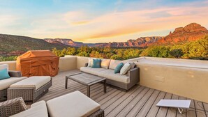 A rooftop patio with outdoor furniture, a grill, and a view of a mountainous landscape. - The Belvedere // Hot Tub, Sauna & Red Rock Views (Sedona)