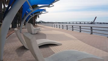 A waterfront promenade with modern seating and a view of the sea.