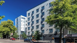 A modern multi-story building with a flat facade, large windows, and balconies. - Modern Studios next to Railway Station (Lahti)