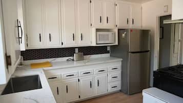 Fridge, microwave, toaster, dining tables