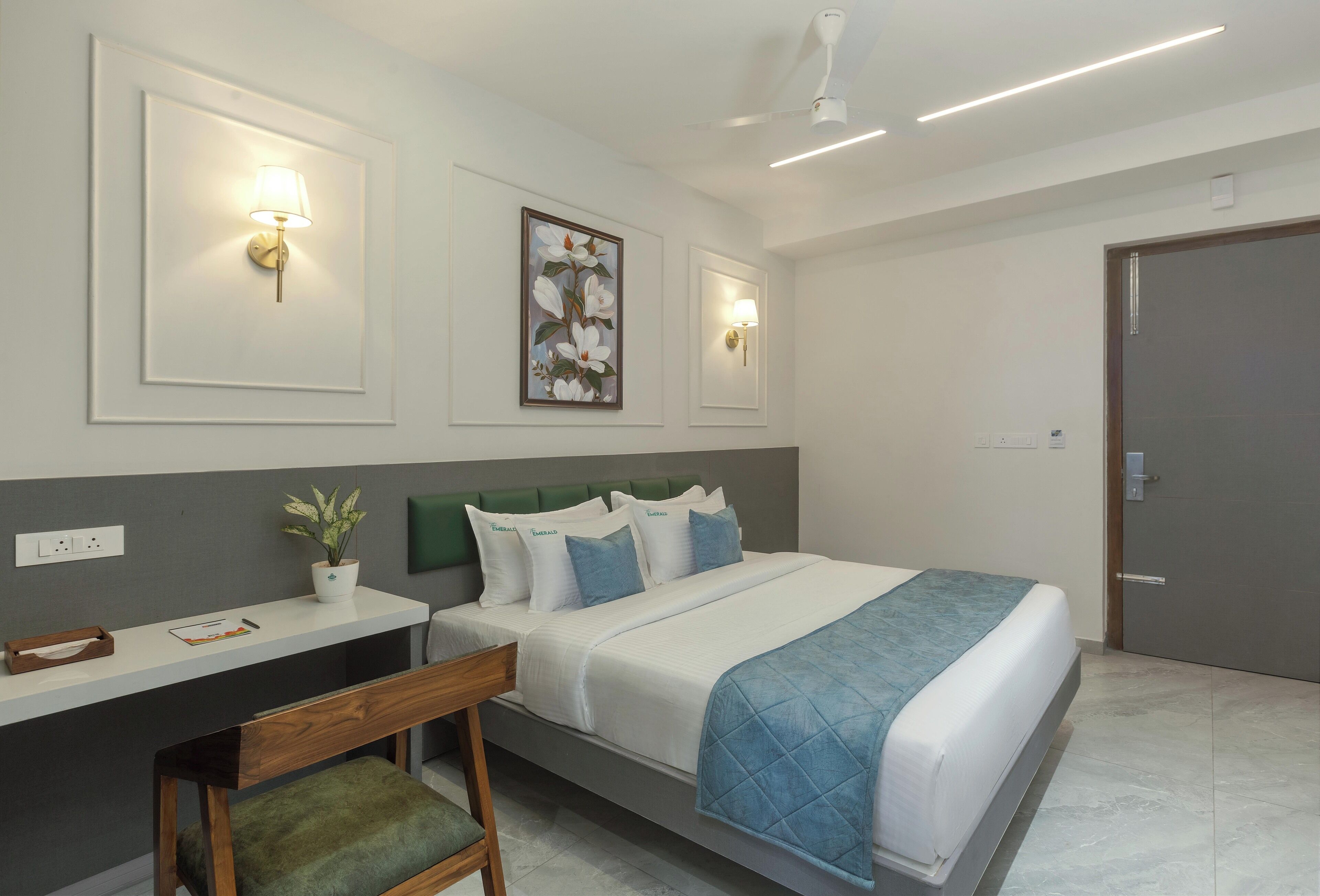 A neatly arranged bedroom with a bed, bedside table, and a chair.