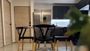 A modern kitchen with a dining area. - Modern Condo - Beautiful City & Volcano Views - 5 min to WTC & Top Places (San Salvador)
