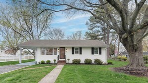 A single-story house with a front porch, a large tree in front, and a well-maintained lawn. - Beautiful 3 Bedroom Retreat walking distance to Downtown St. Michaels (Saint Michaels)