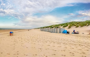A beach with portable toilets and a trash bin. - Awesome apartment in Bredene (Bredene)