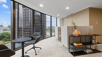 Enjoy a panoramic view of the city from this stylish office space with floor-to-ceiling windows.