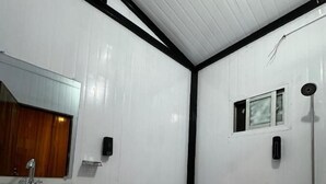 A bathroom with a white sink, toilet, and shower. - Infinity Villa and Resort Kumrat Valley (Kumrat Valley)